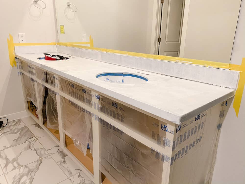 Bathroom vanity with one coat of primer on the countertops 