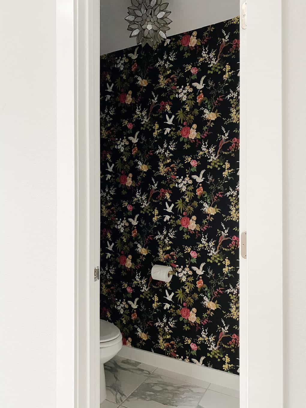 small water closet with black floral wallpaper