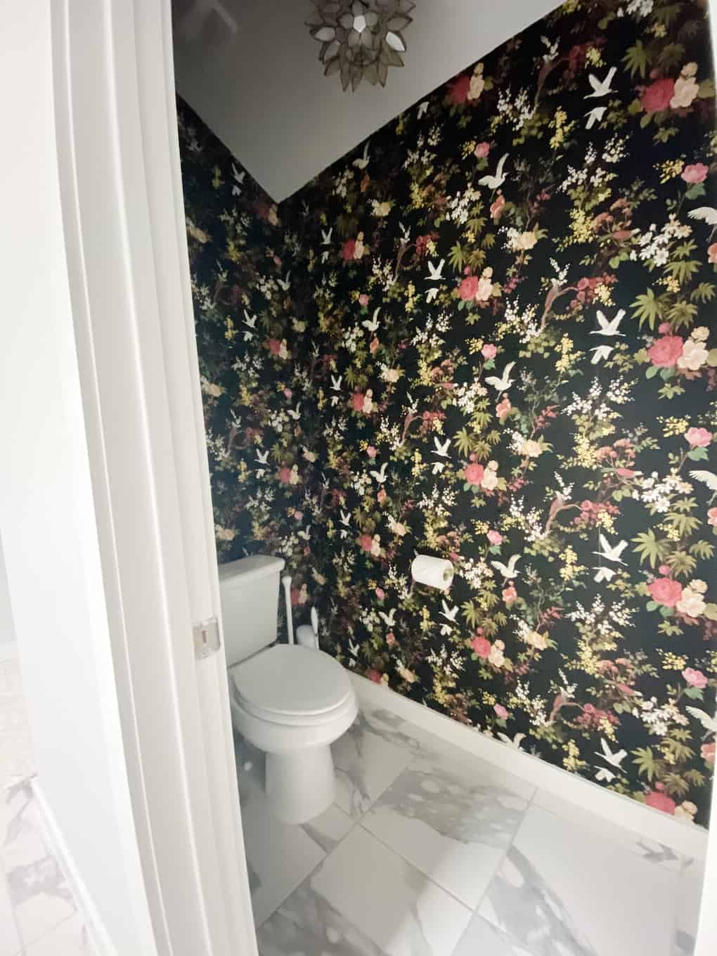 water closet with bold black floral wallpaper