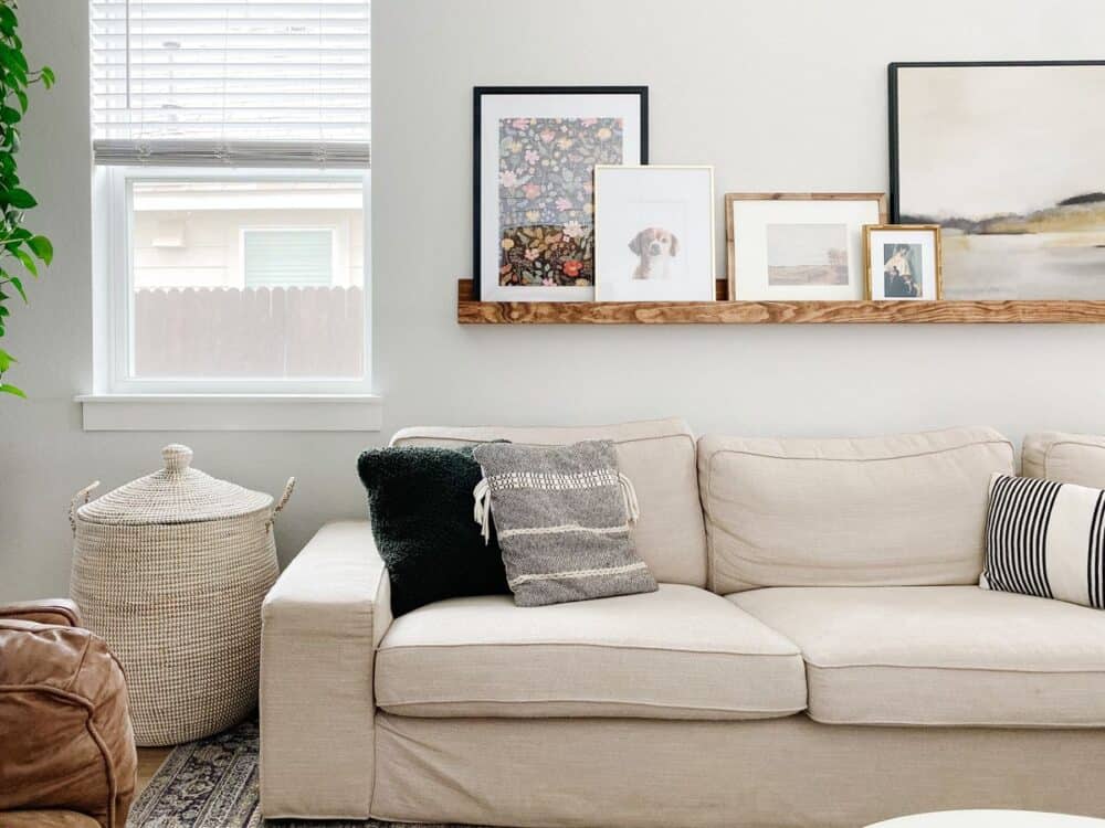 living room with a white sofa and a large basket for blankets 