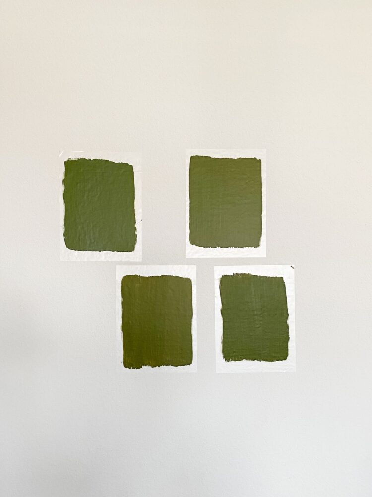 four green paint swatches on a wall