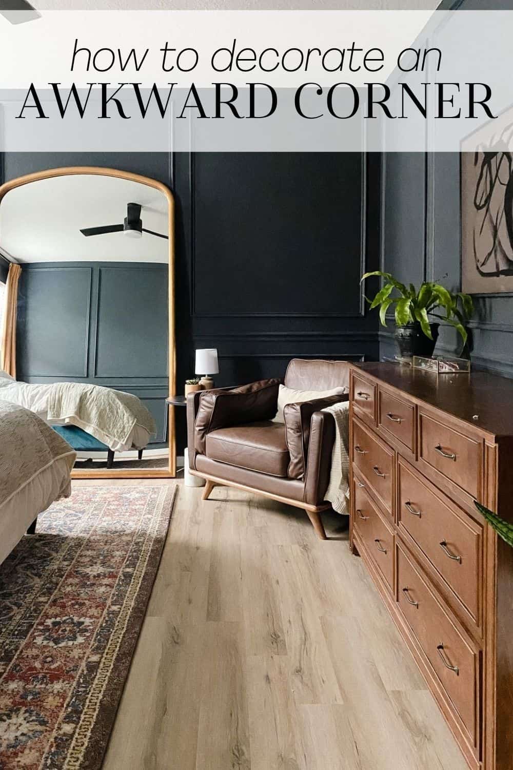 a bedroom with dark walls and a cozy armchair. Text overlay says "how to decorate an awkward corner"