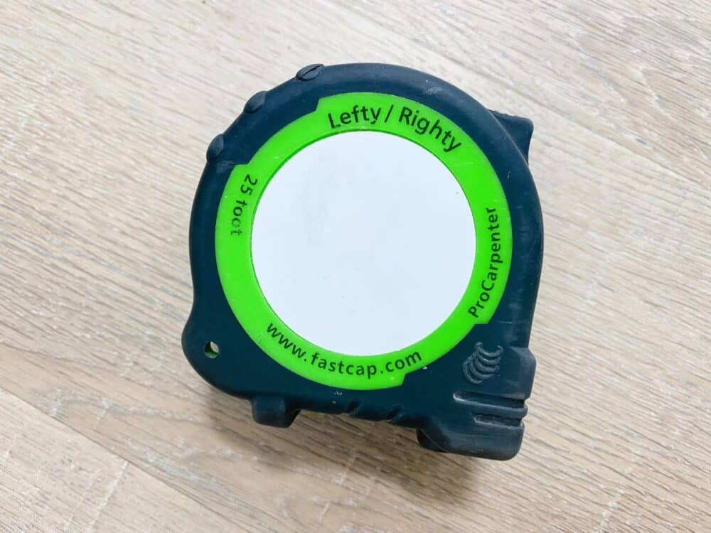 close up image of a fastcap lefty/righty tape measure 