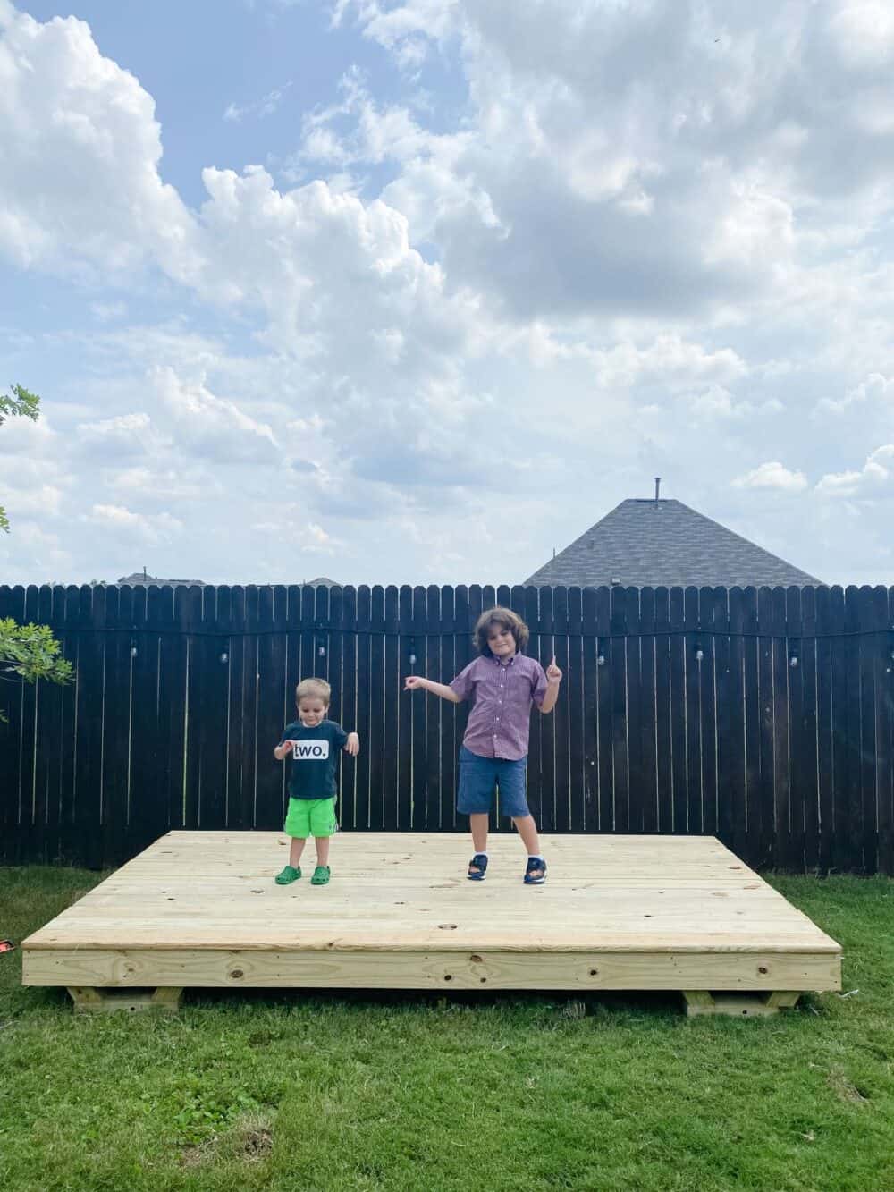 Two young boys on the base of a playhouse 