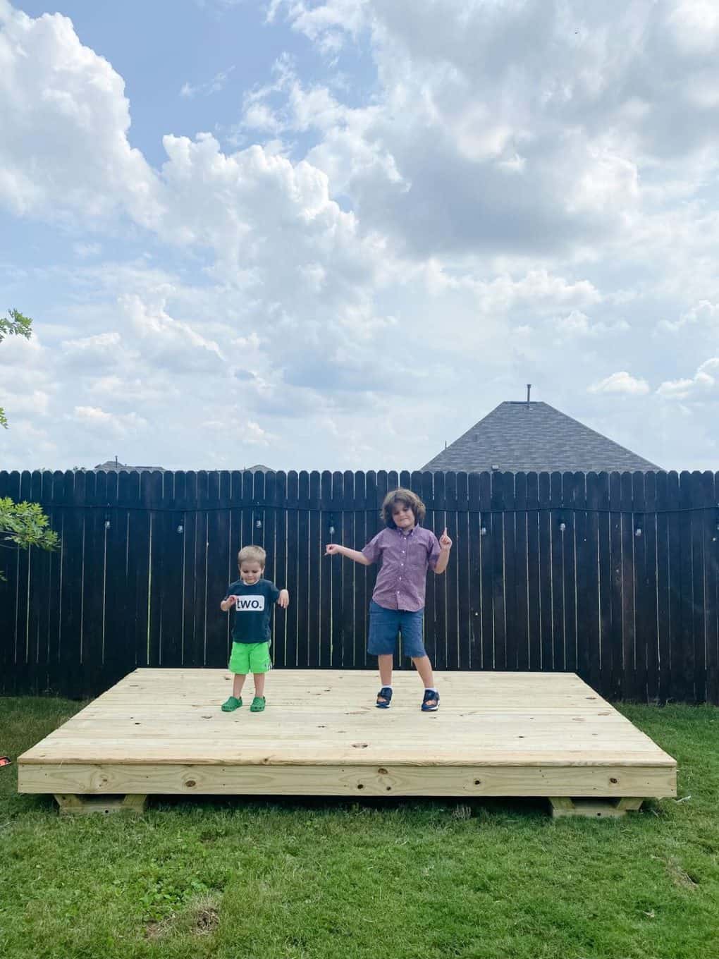 Two young boys on the base of a playhouse