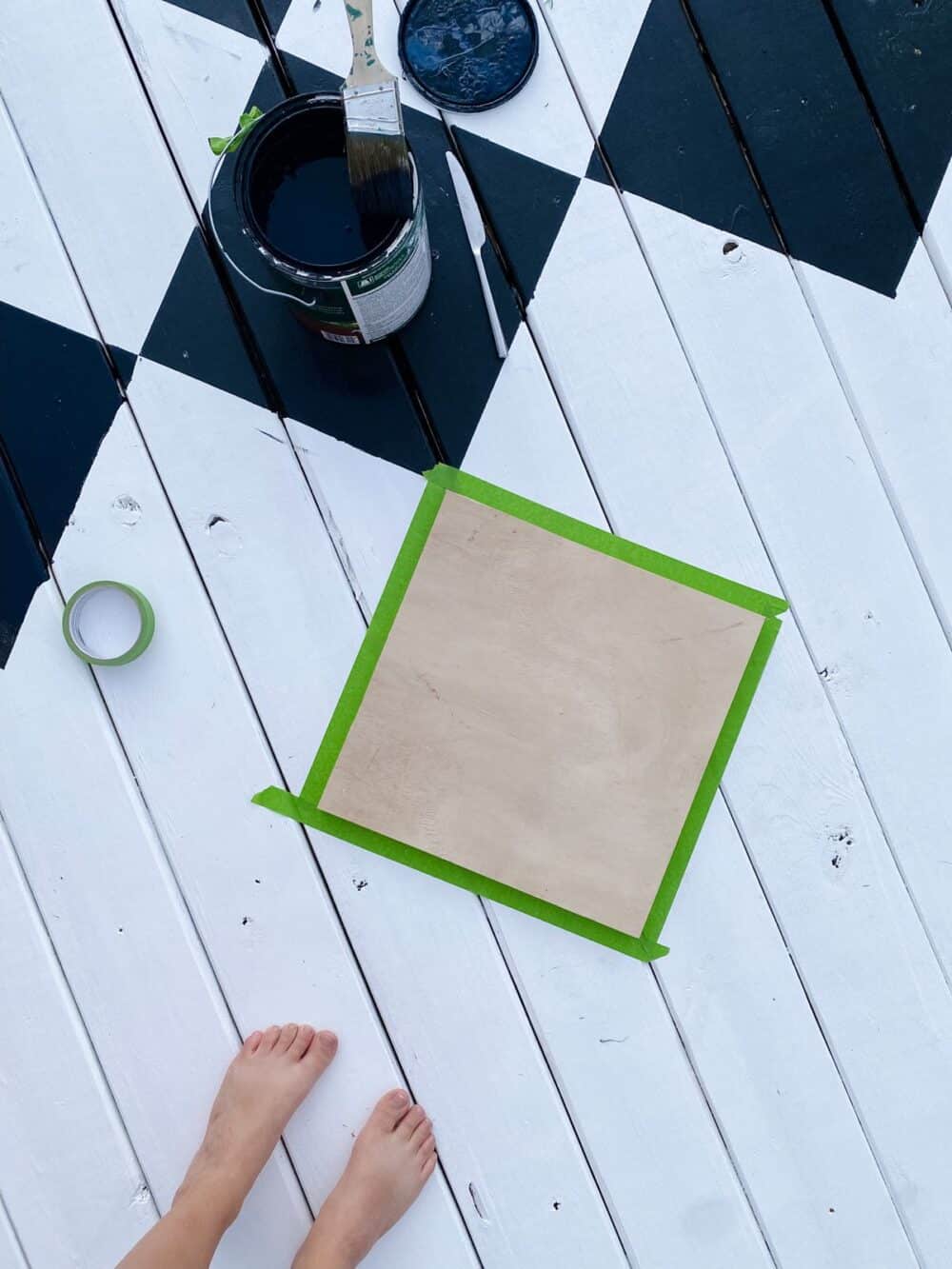 overhead view of painted decking with template for painting a diamond pattern