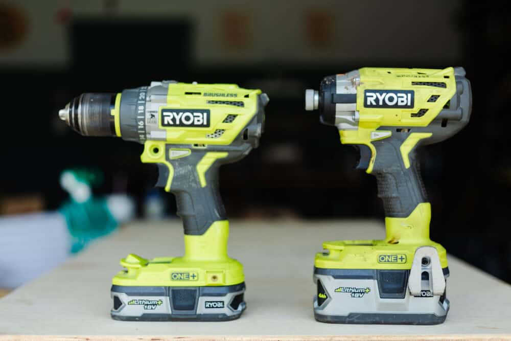 A Ryobi drill and impact driver sitting next to each other