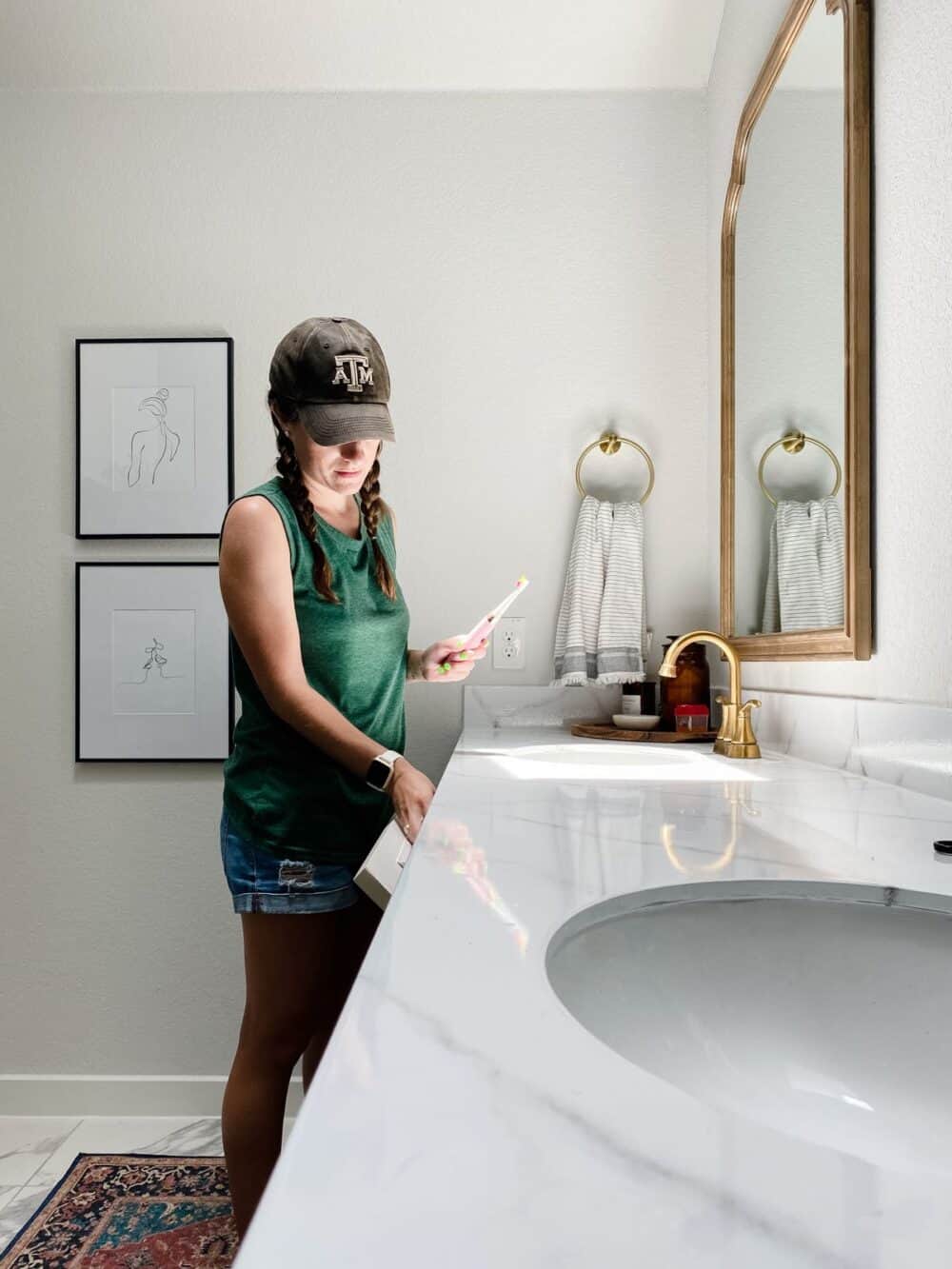 Woman getting a toothbrush from a tilt-down drawer in vanity