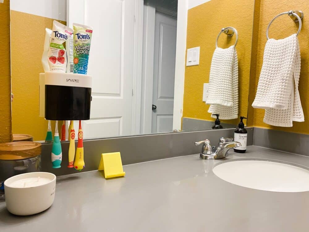 Bathroom with toothbrush holder on mirror 