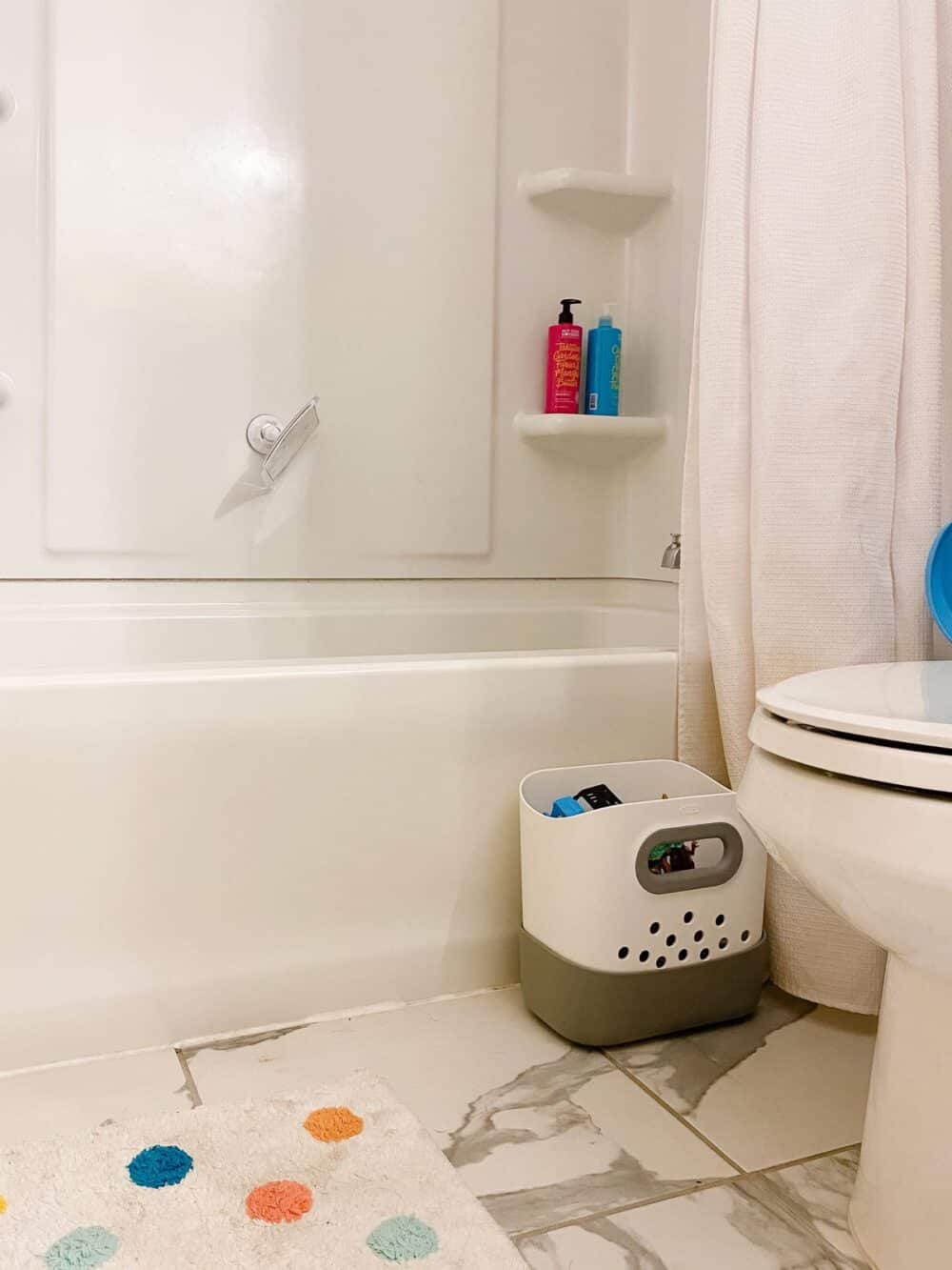 Children's bathroom with a plastic toy storage bucket 