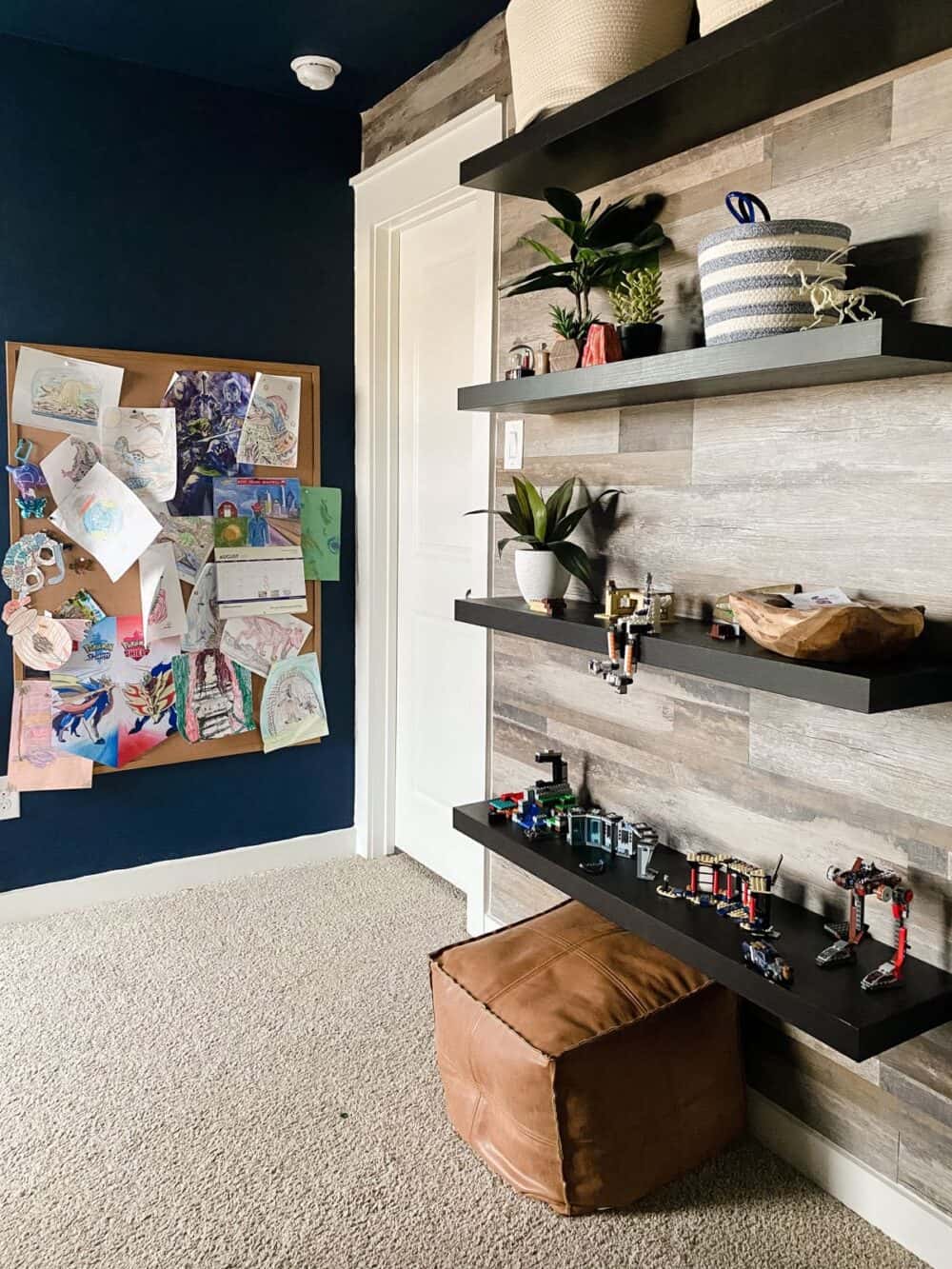 A navy blue bedroom with a faux wood accent wall