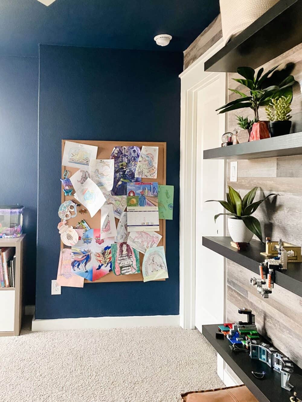 Kids' bedroom with navy blue walls and a painted ceiling