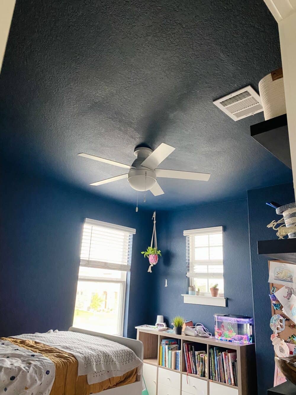 Kid's bedroom with blue painted ceiling