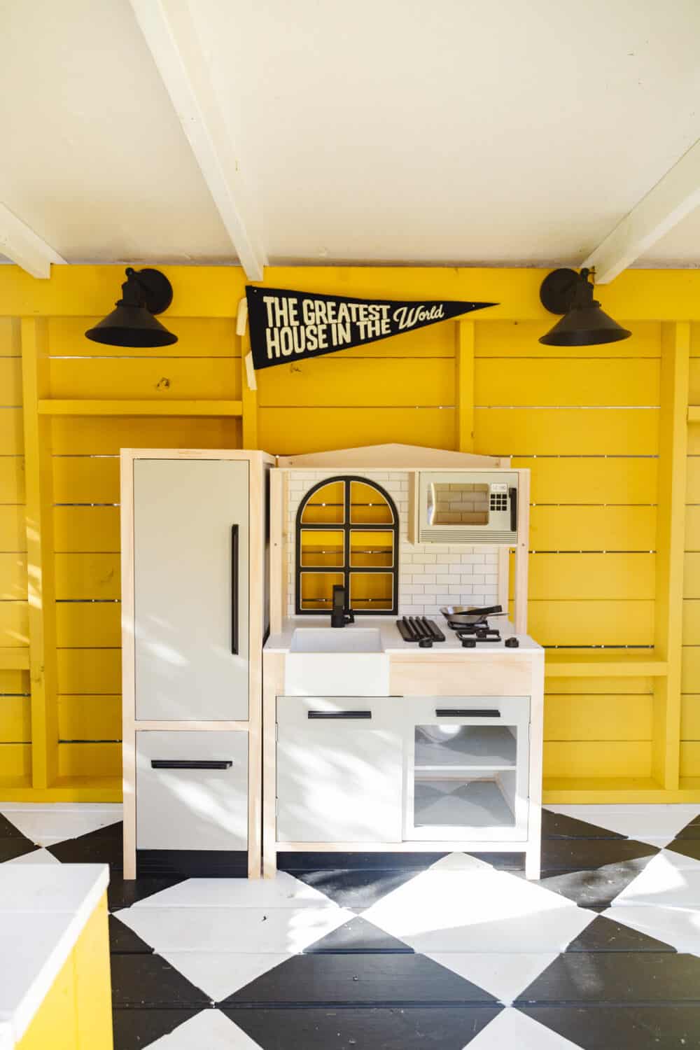 Small play kitchen inside an exterior playhouse