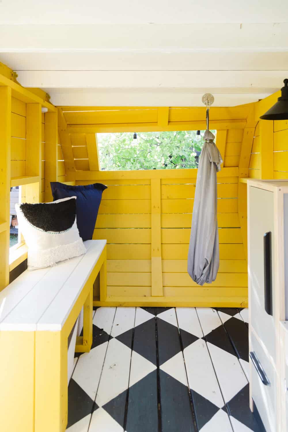 Camper playhouse with built-in bench and a swing