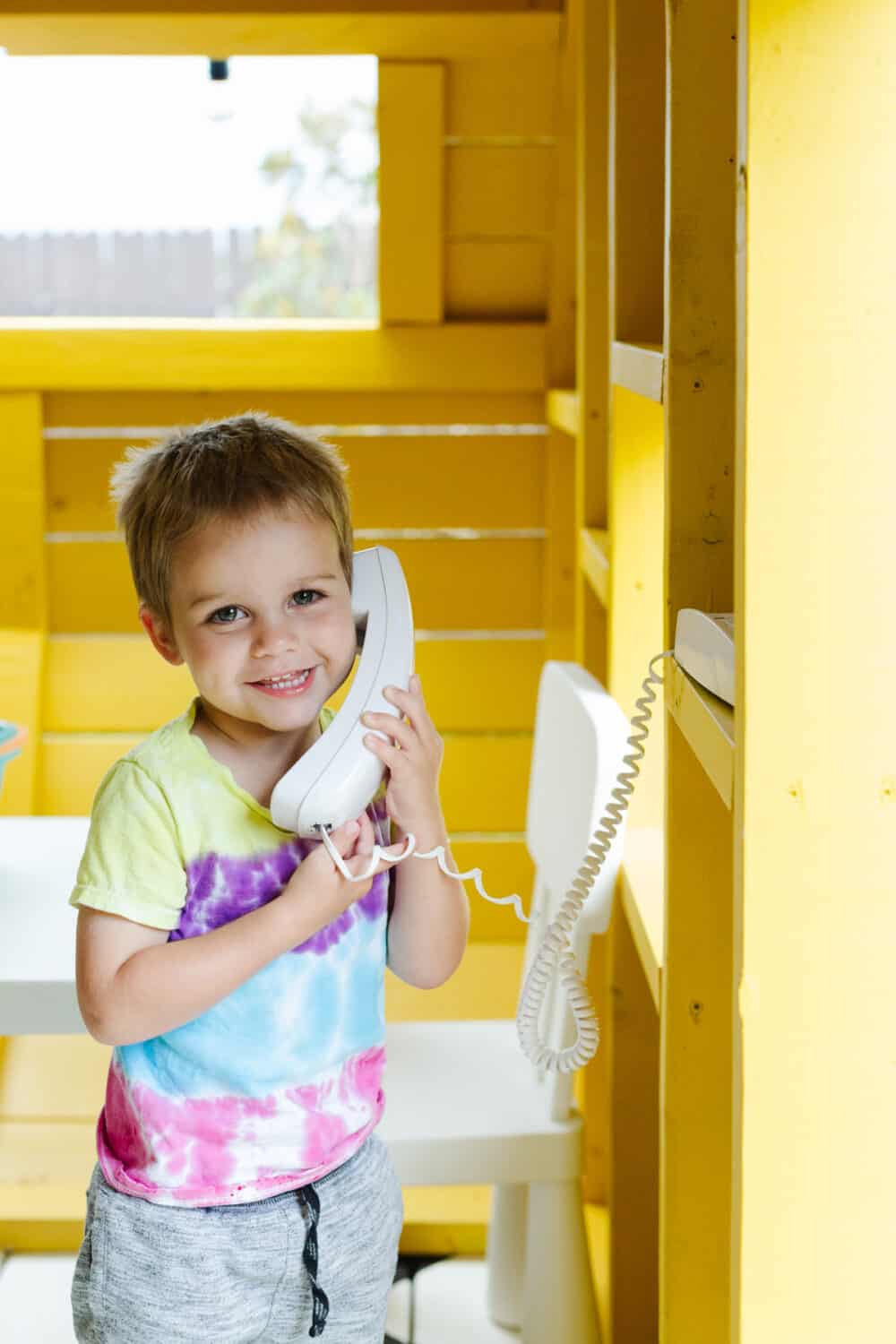toddler on a play telephone
