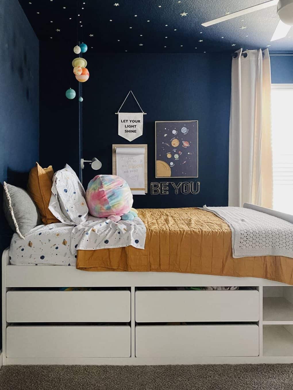space themed kids bedroom with yellow bedding
