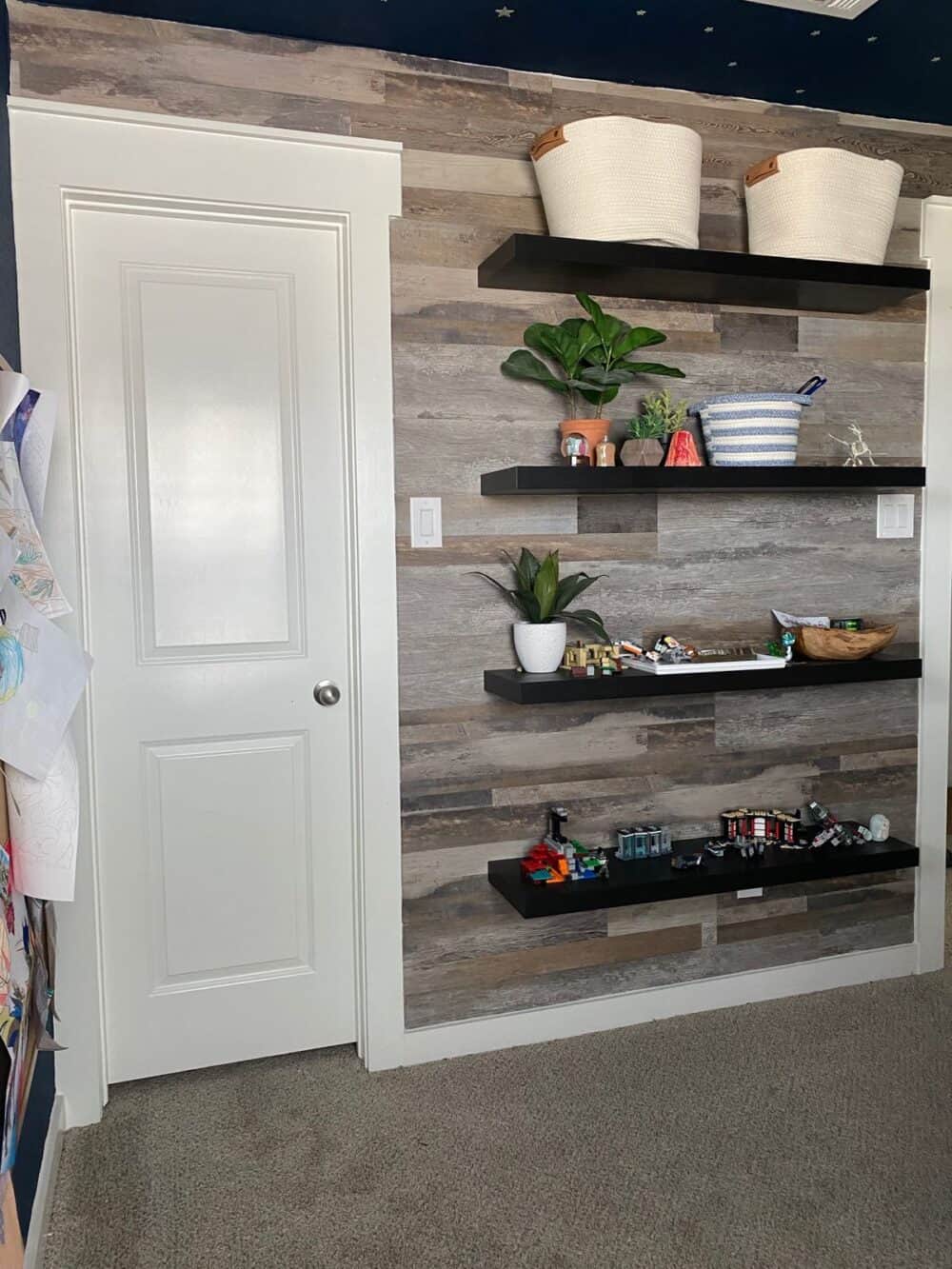 A child's bedroom with a faux wood accent wall