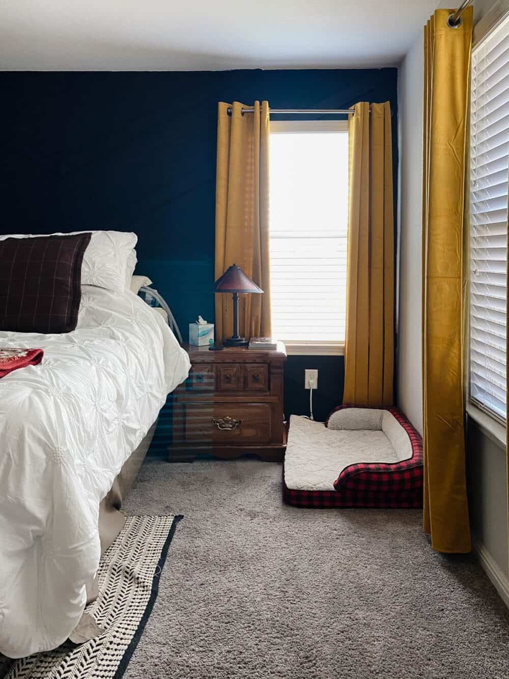 A cozy bedroom with a black accent wall