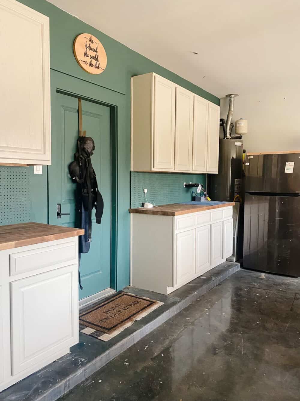 An organized garage with cabinets installed on one wall