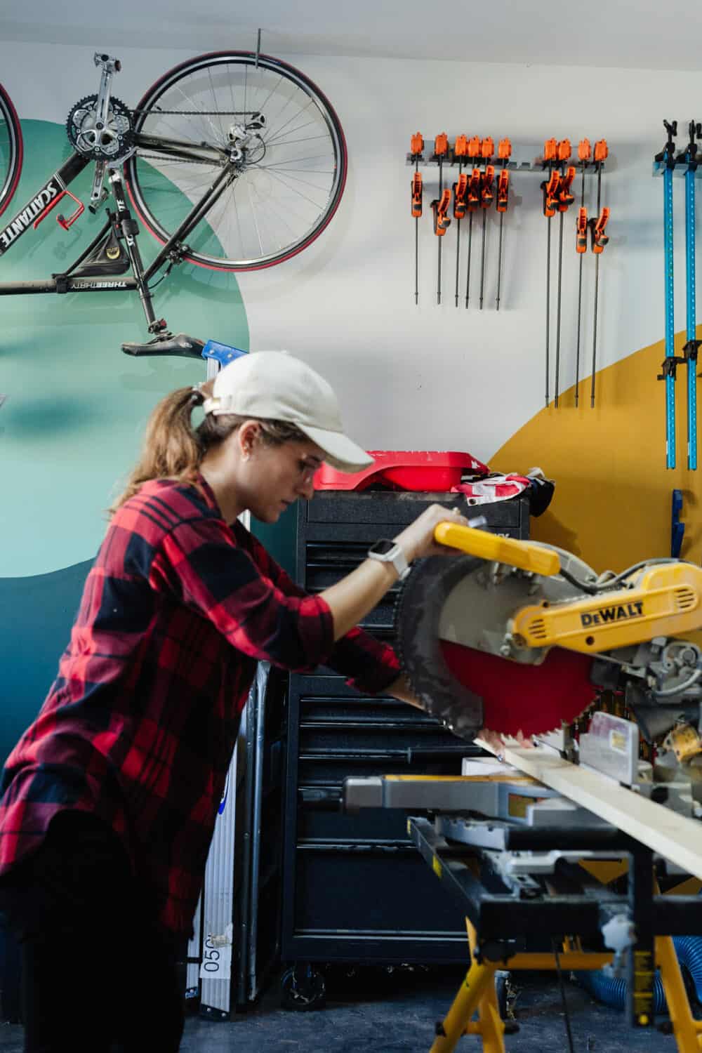 woman operating a miter saw 