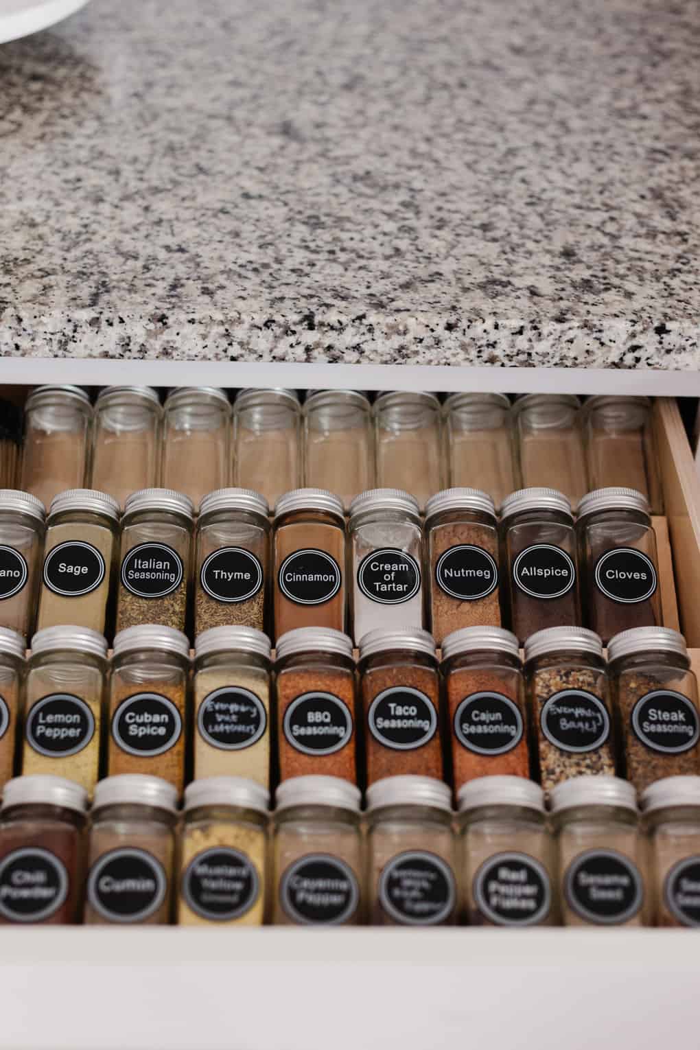 close up of spice bottles in a spice drawer 