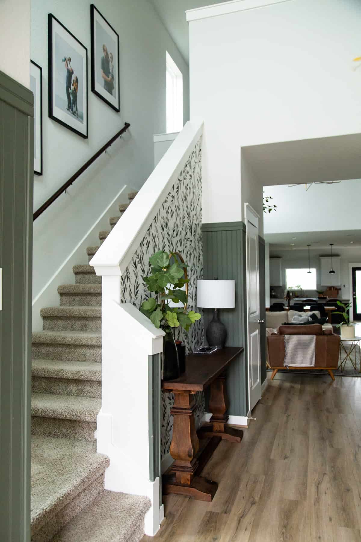 Entry with green bead board and floral wallpaper 