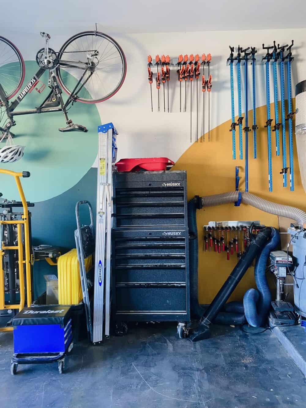 Colorful garage with lots of workshop organization on the walls 