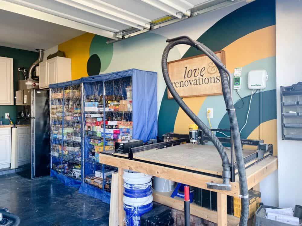 Colorful garage with an X-Carve and shelves holding board games 