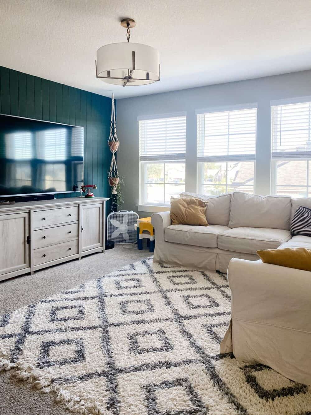 Family room with an accent wall painted behr's black evergreen 