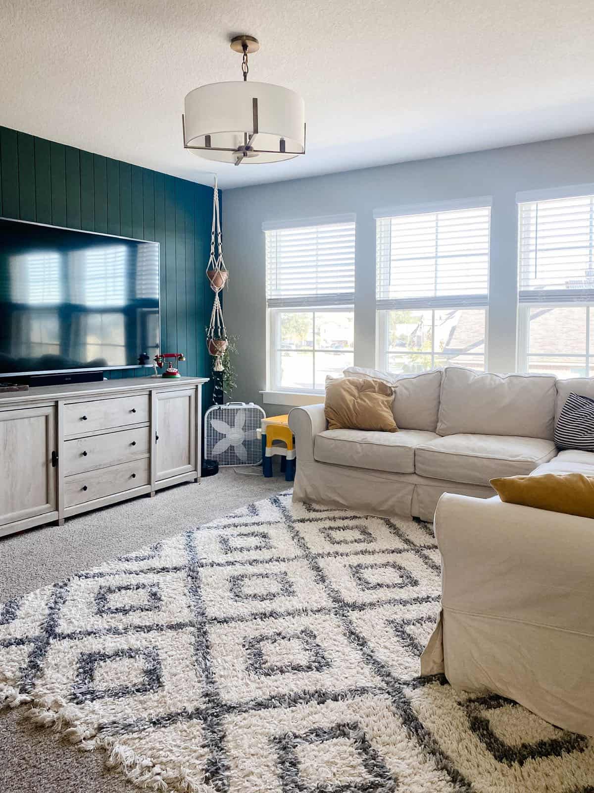 family room with vertical shiplap painted dark green