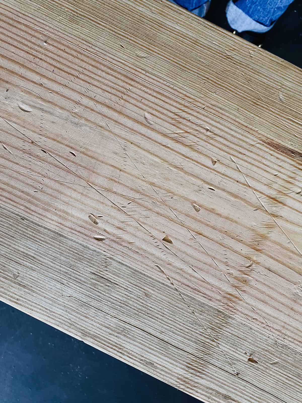 Close up image of distressing on DIY wood bench 