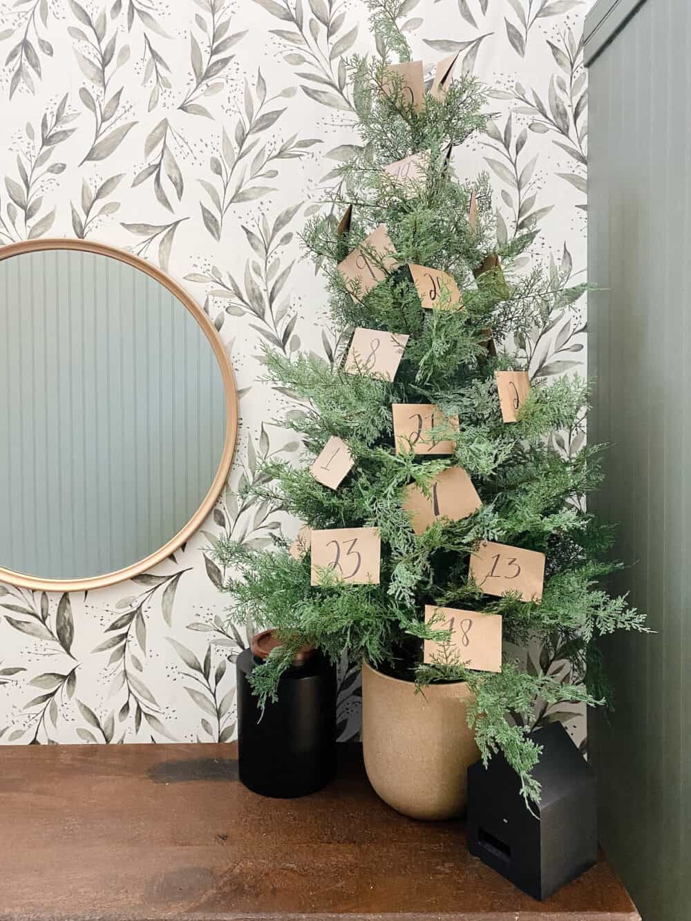 small tabletop tree with envelopes being used as an activity advent calendar 