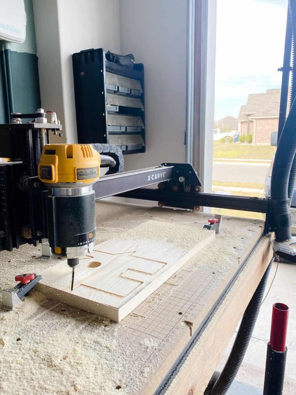 X-Carve machine cutting out a house for a Christmas village
