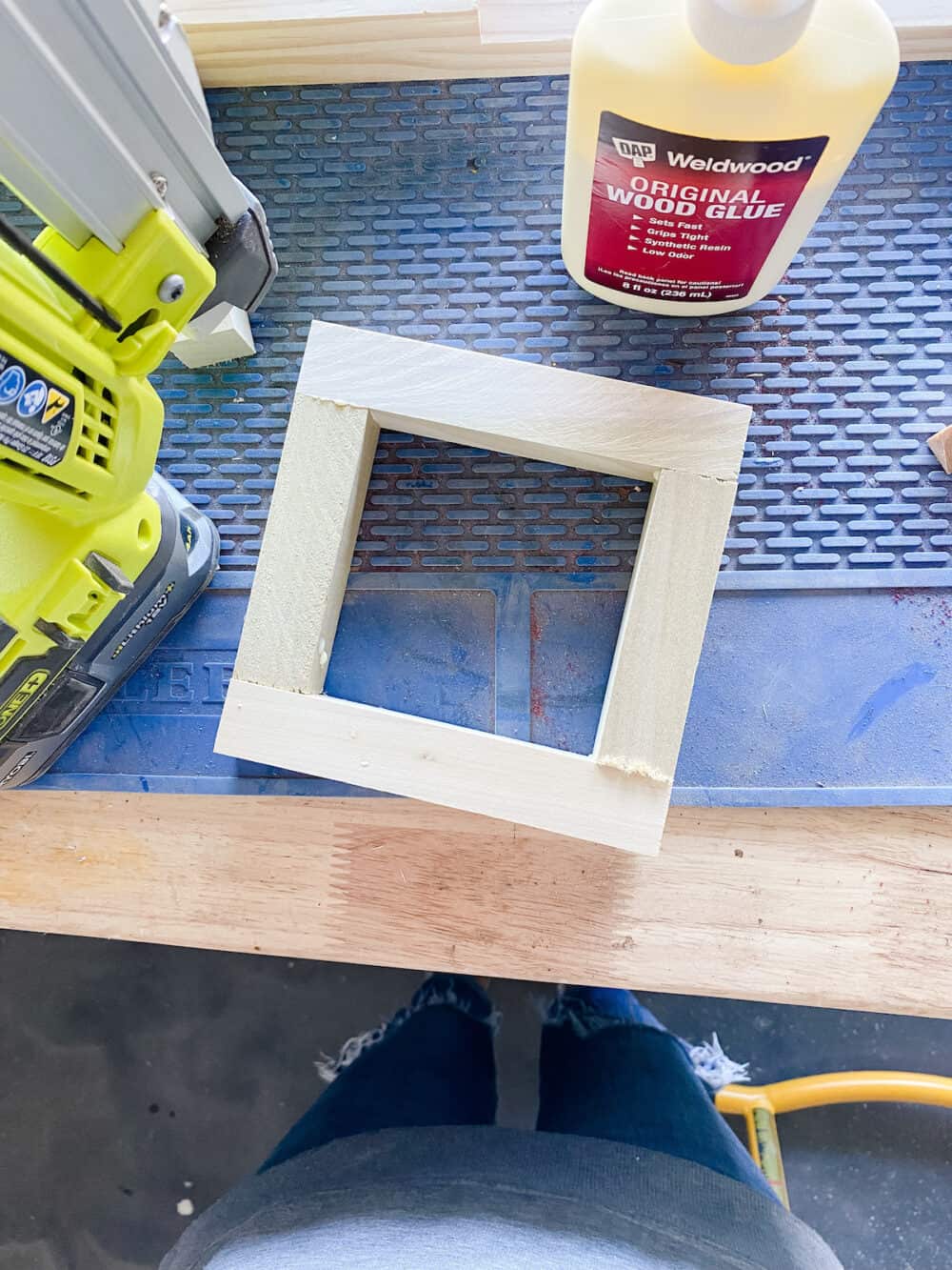 square shape created out of wooden dowels to create a wood lantern