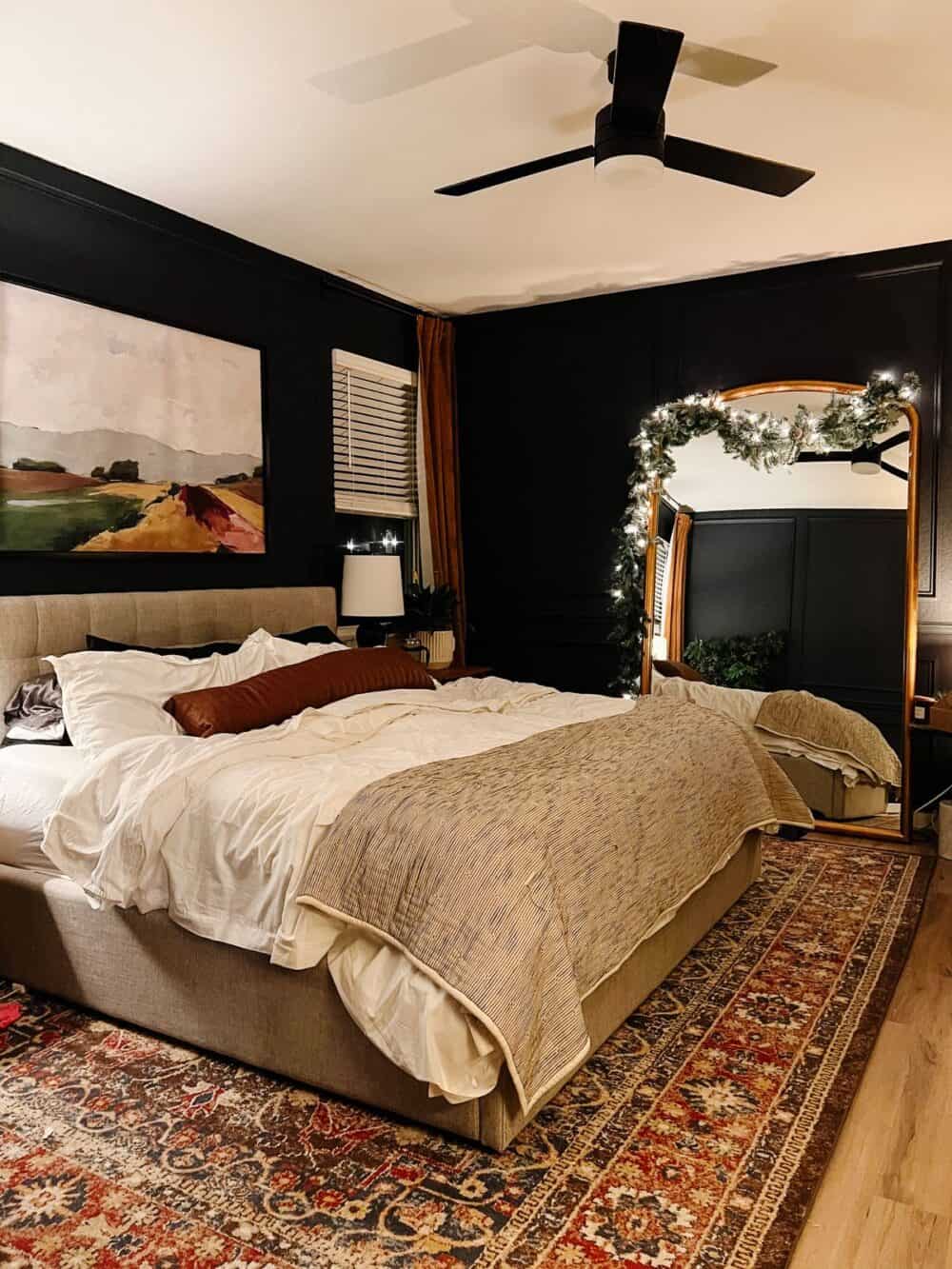 Bedroom with a large mirror decorated for Christmas 