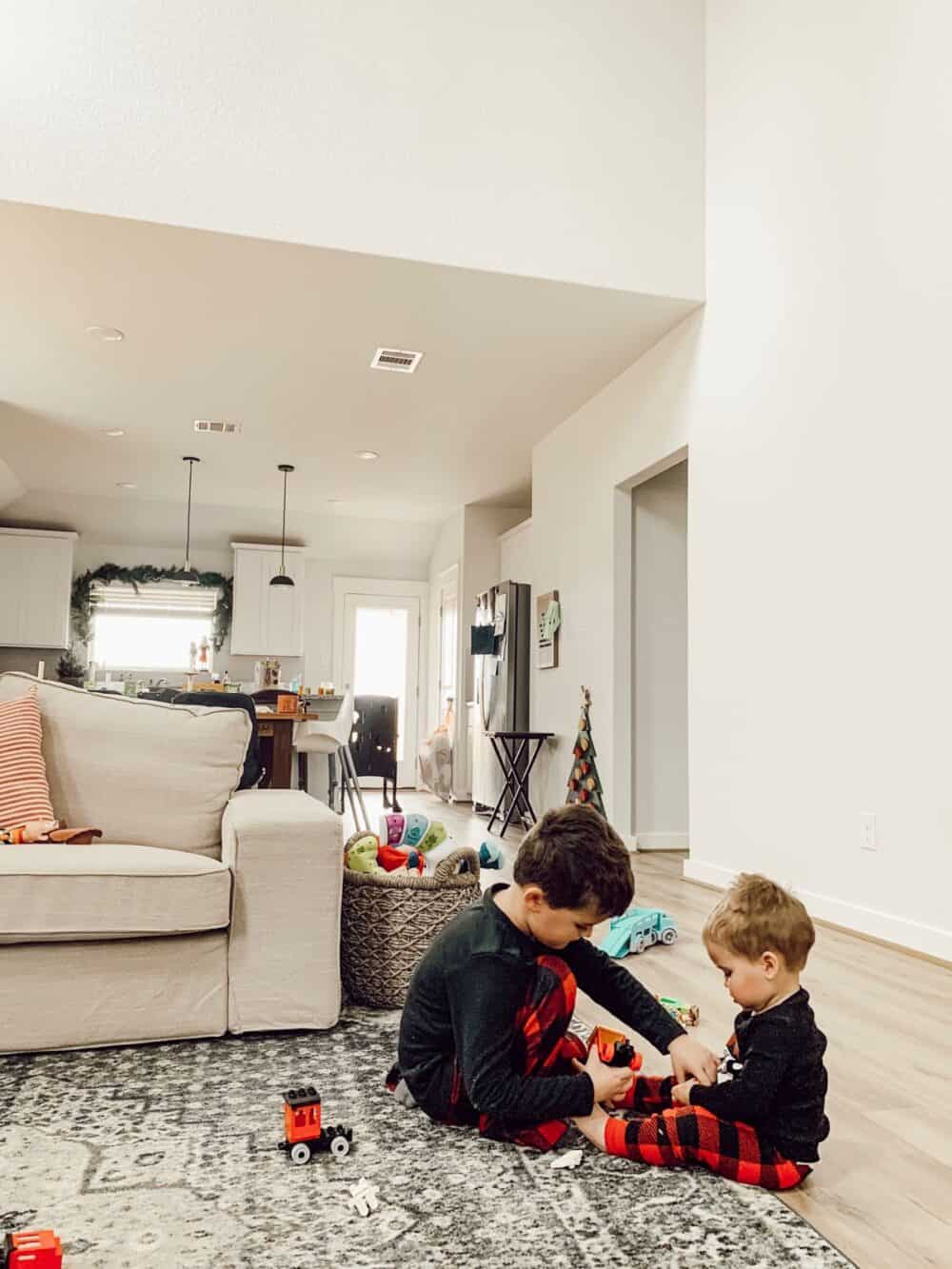 two small boys playing together on Christmas morning