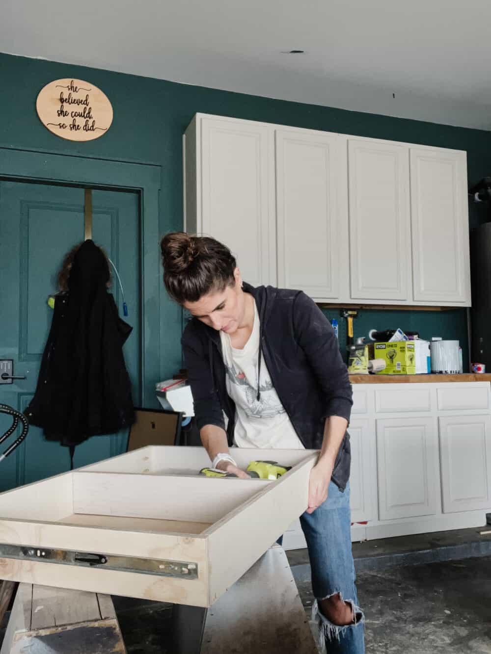 Woman installing dividers in a drawer for a kitchen cabinet