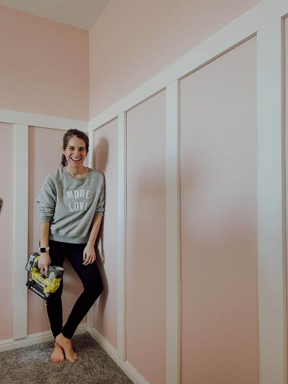 Woman standing next to a board and batten wall