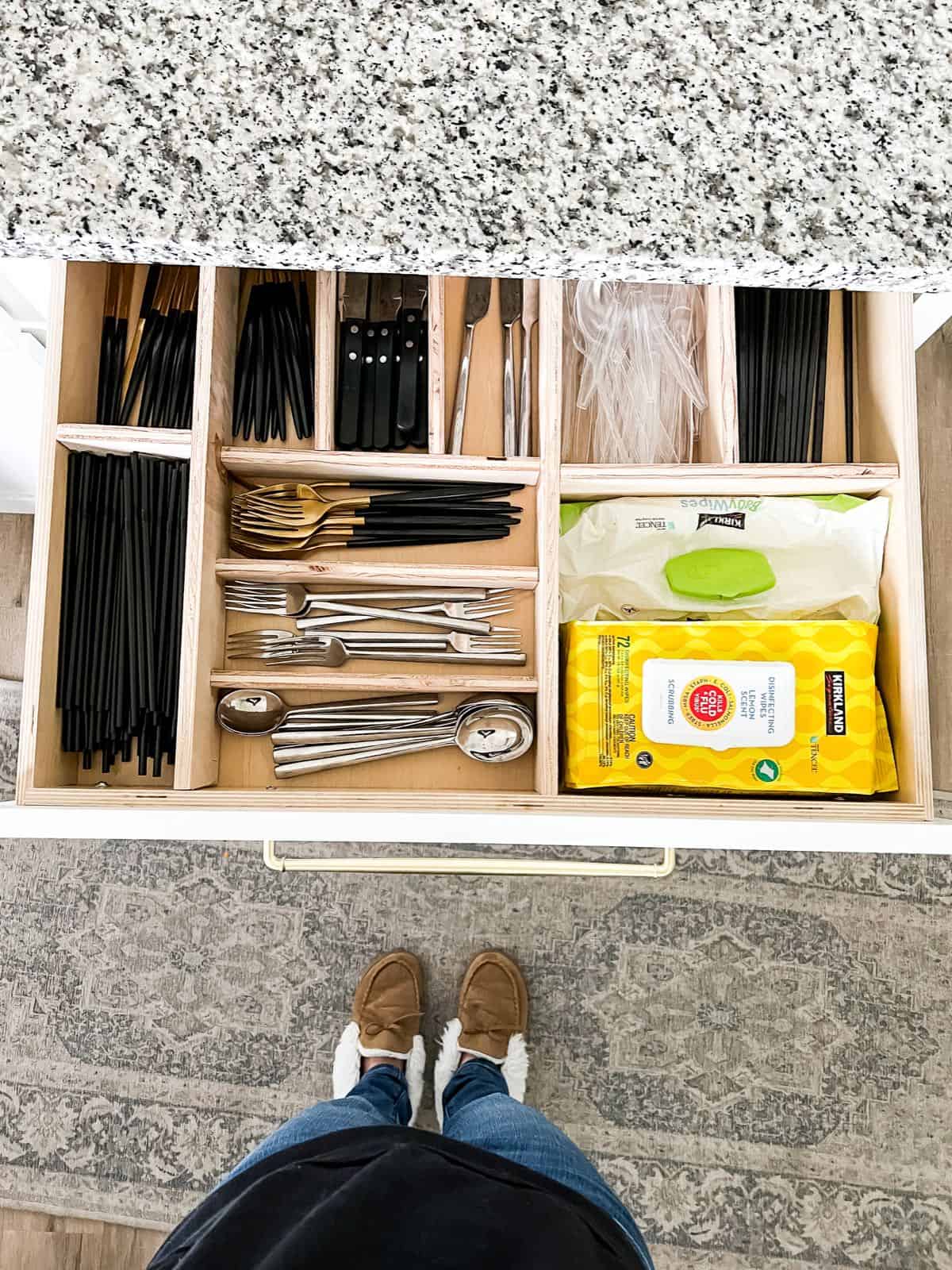 Overhead view of organized silverware drawer with wood drawer organizer