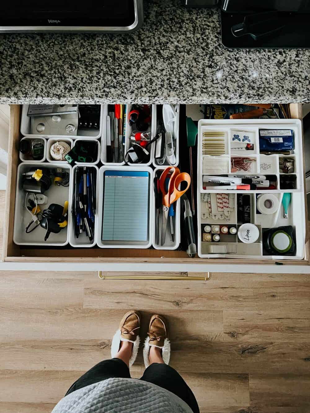 Overhead view of a kitchen junk drawer that has been organized 