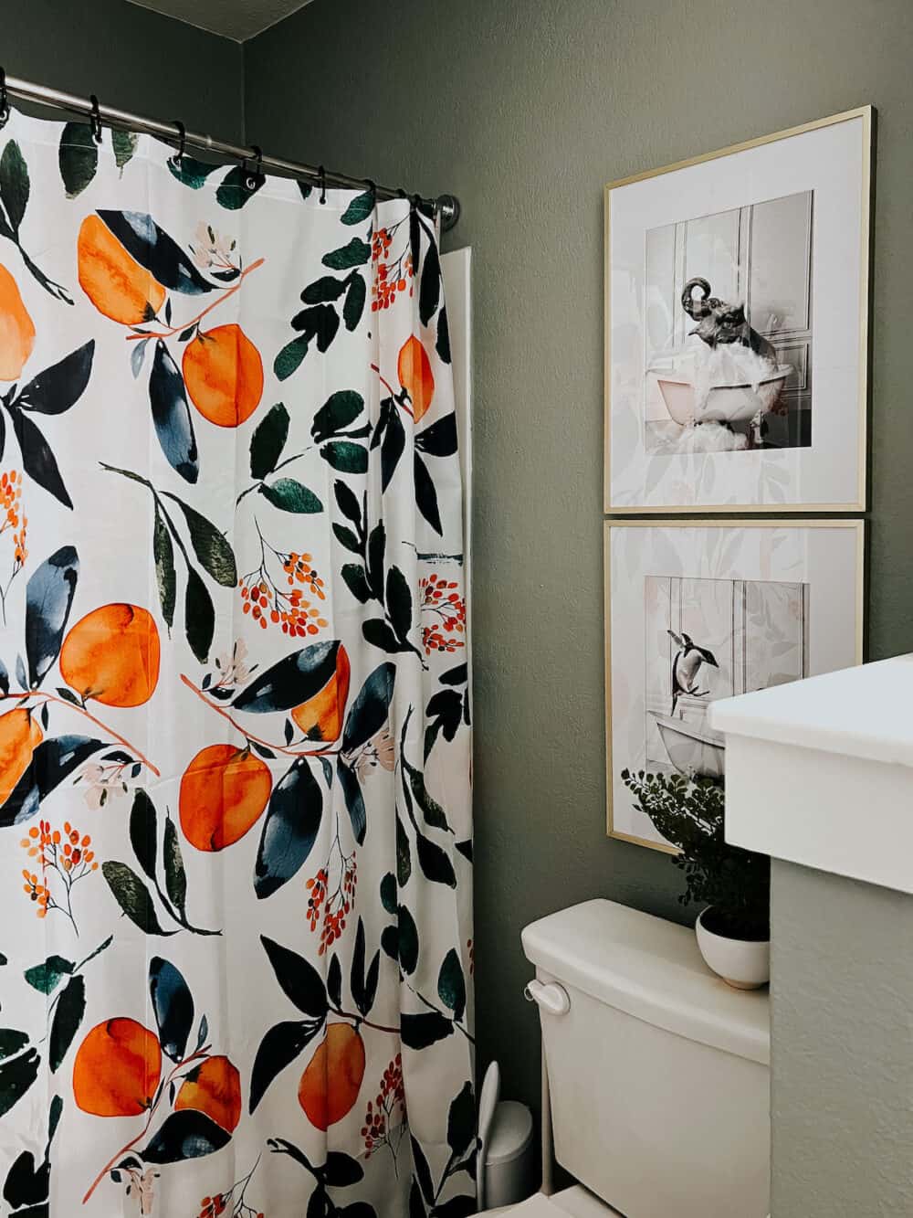 Kids bathroom with citrus shower curtain and animal art 