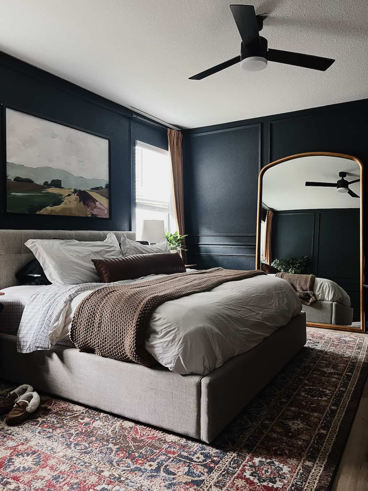 Dark and cozy bedroom with wall trim