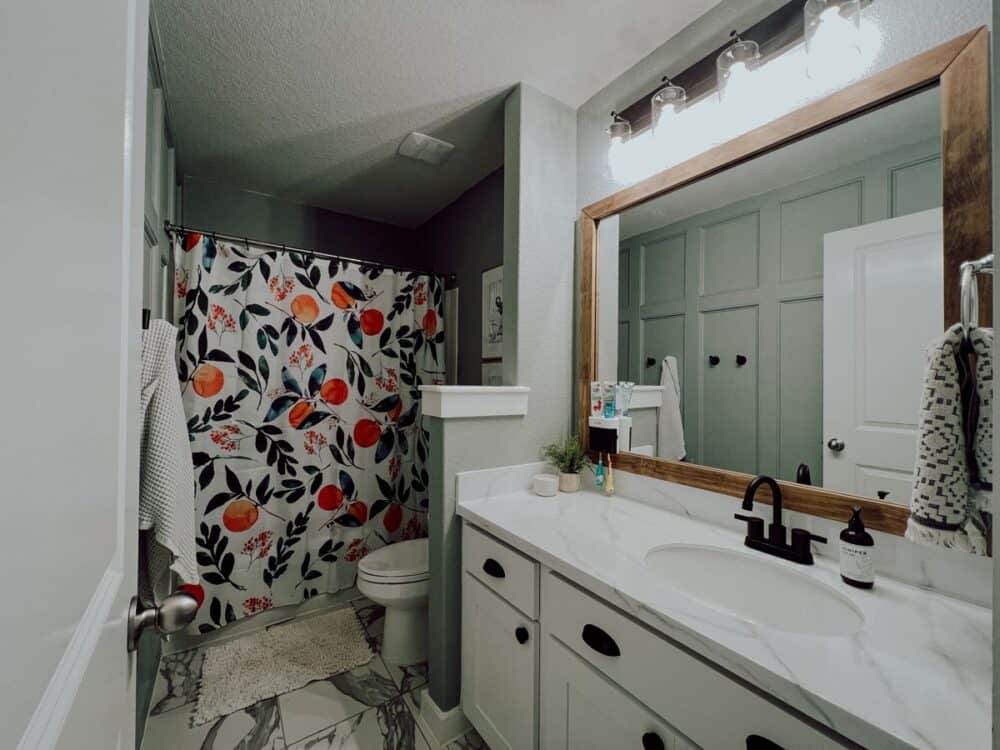 Small bathroom with a framed mirror 