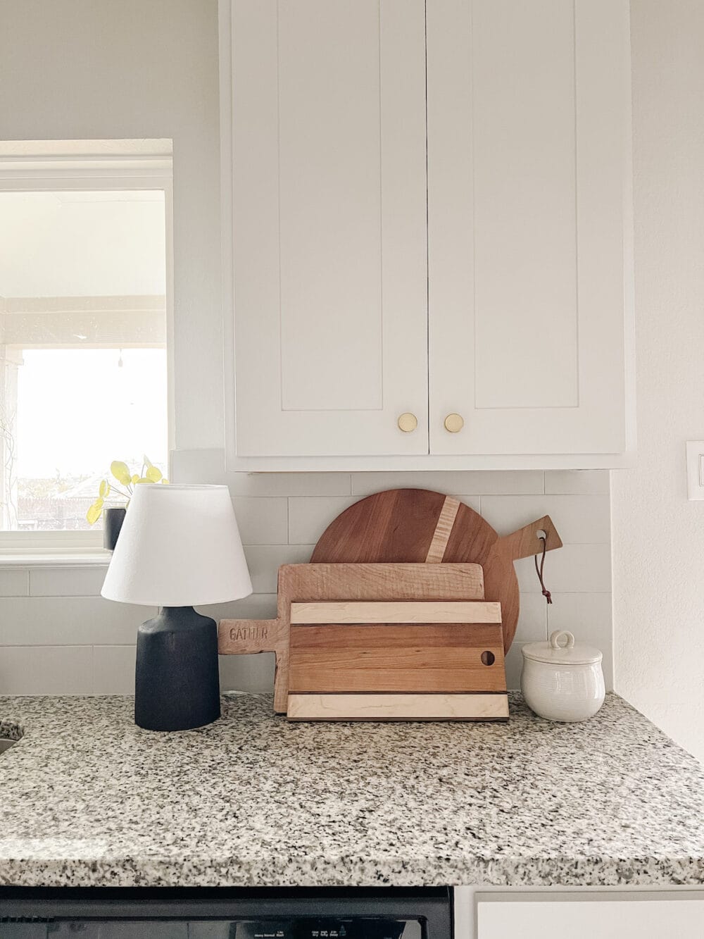 Close up of a kitchen countertop lamp next to some wooden cutting boards