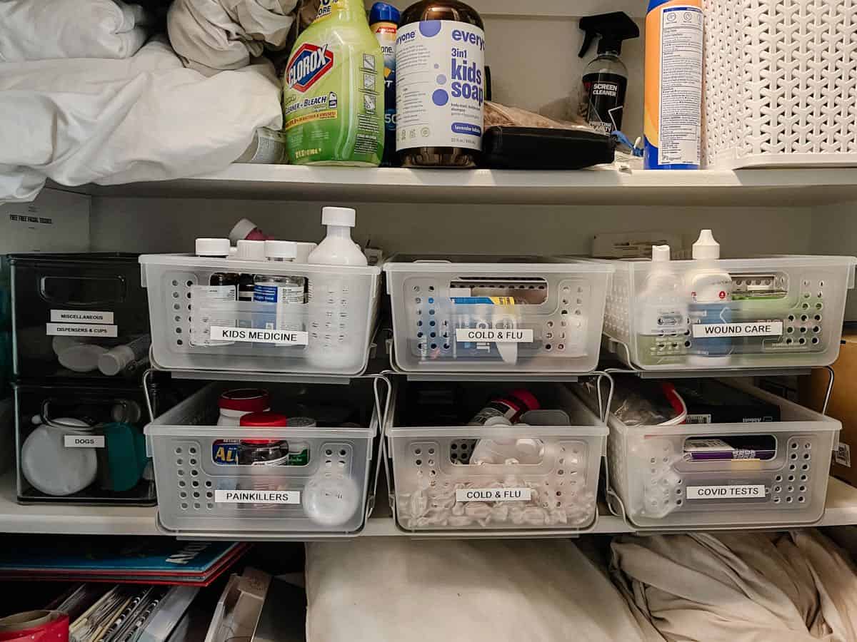 linen closet shelf with organized medicine