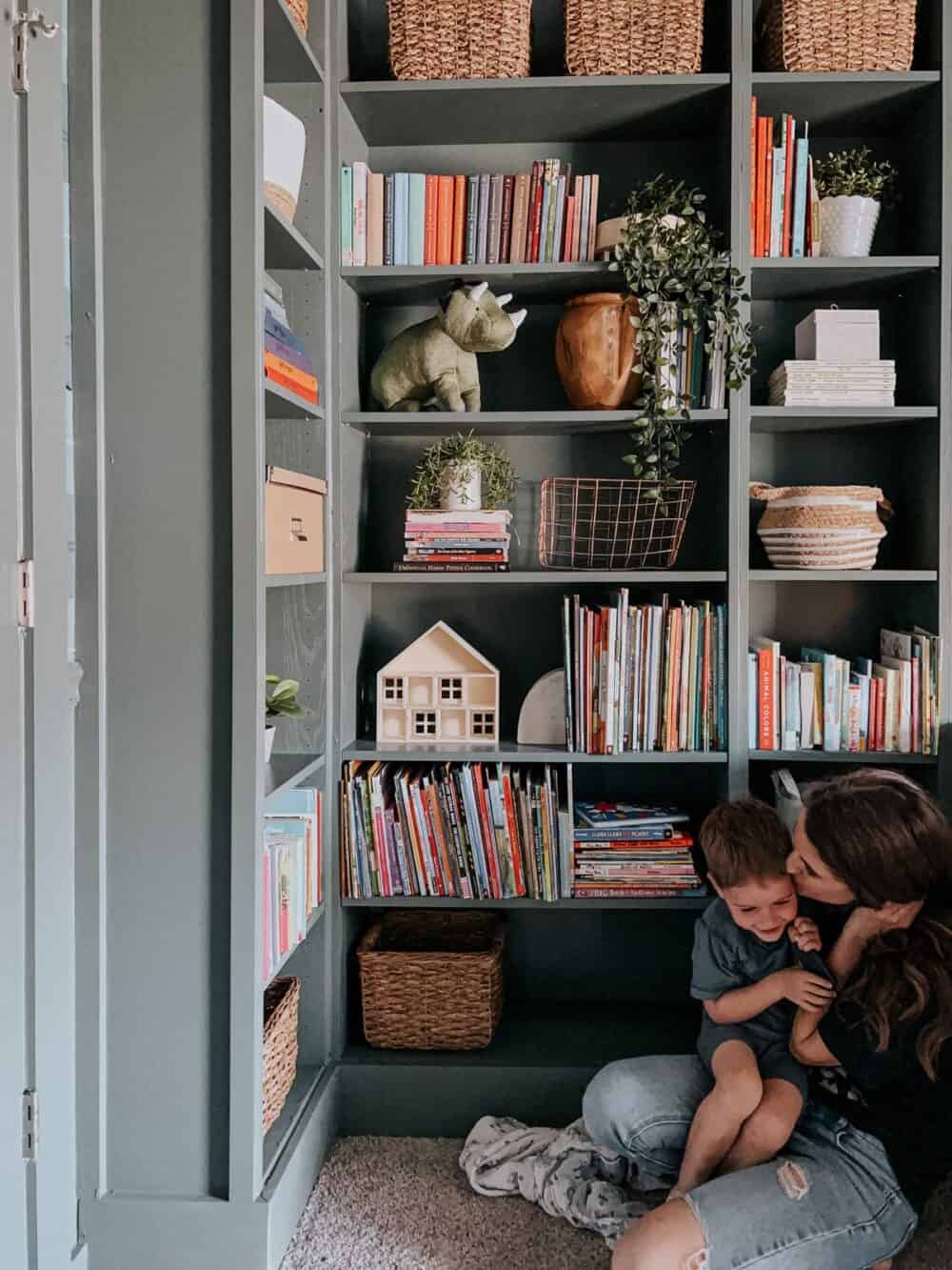 Green bookcases styled with books 