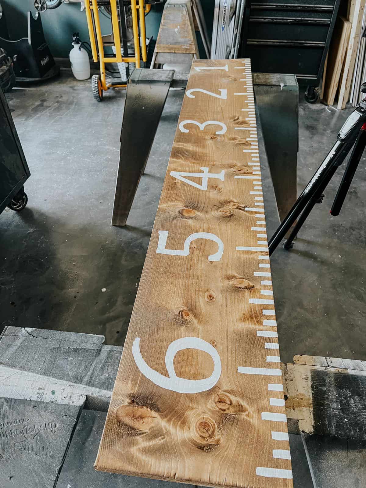Wooden growth chart with numbers painted on