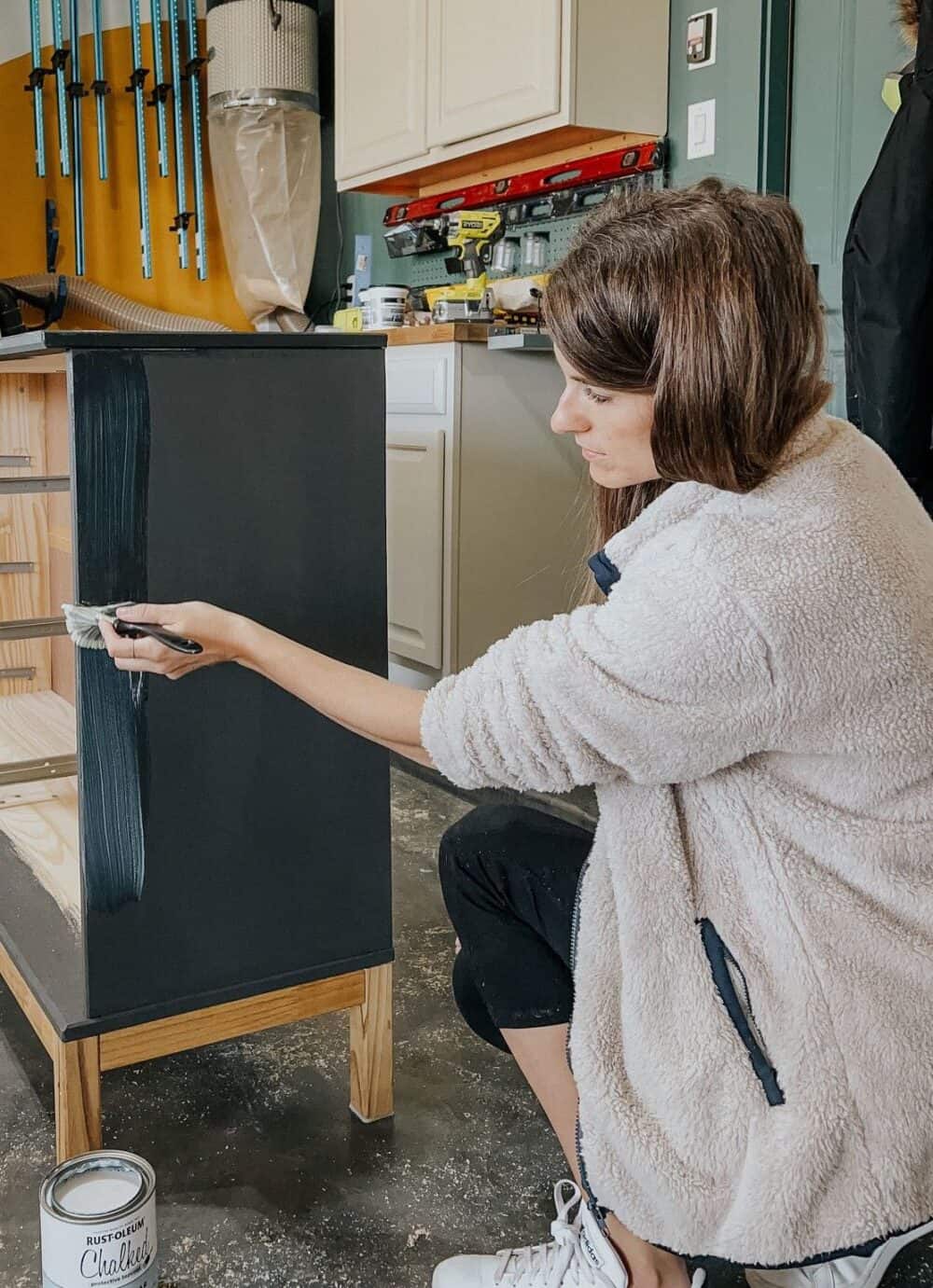 woman sealing a dresser painted with Chalked paint