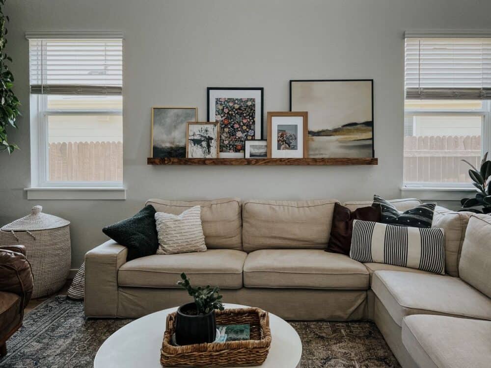 Living room with a picture ledge hanging above a sectional sofa